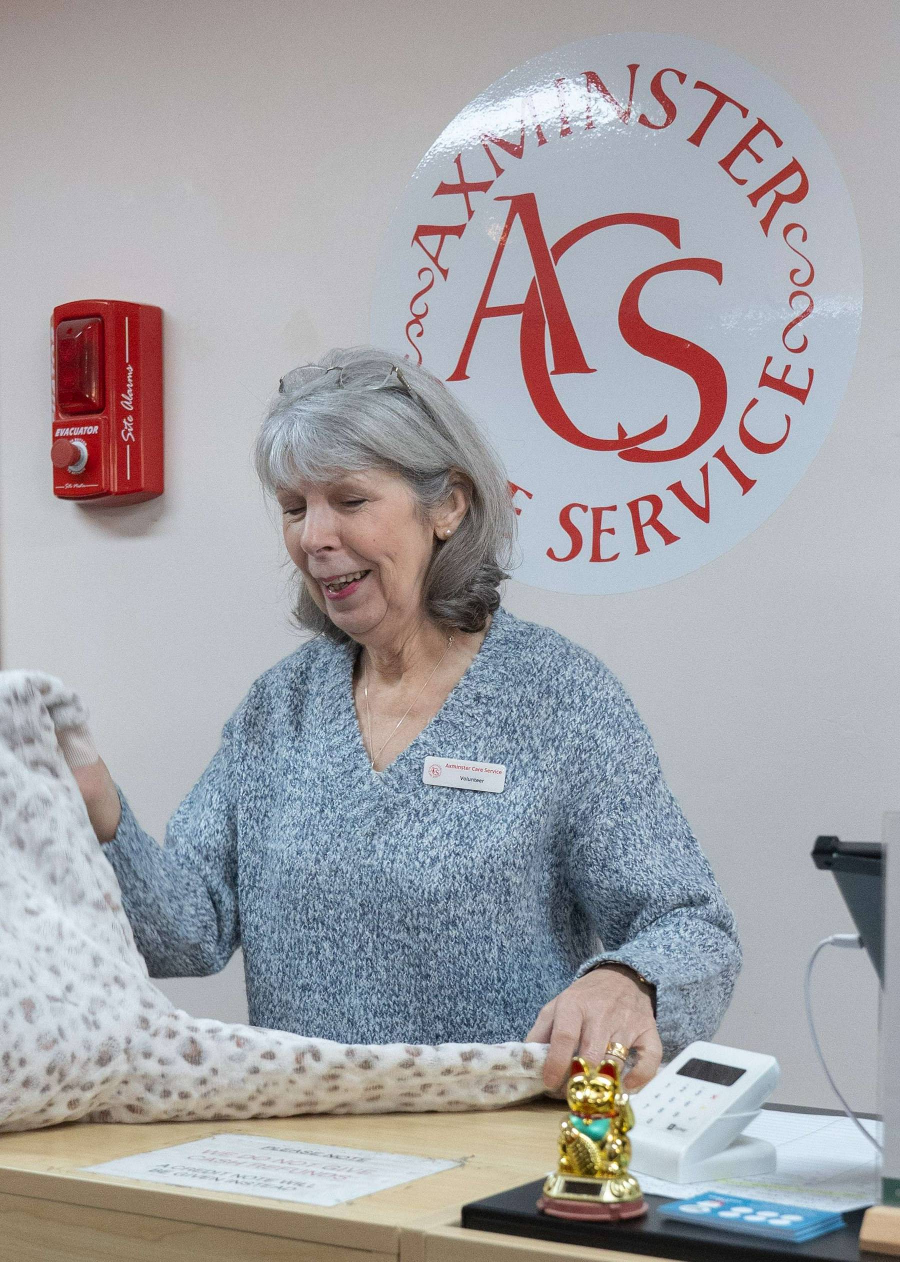 Shop attendant behind till